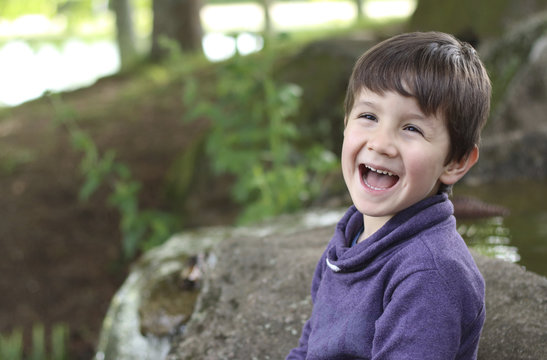 Happy kid laughing in the forest
