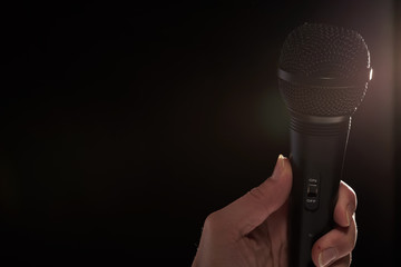 black studio microphone on a dark background