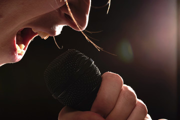 Black studio microphone in hand rock singer