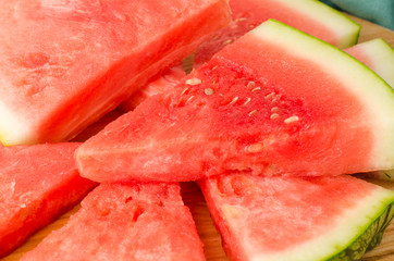 Slices of watermelon on a wood cutting board