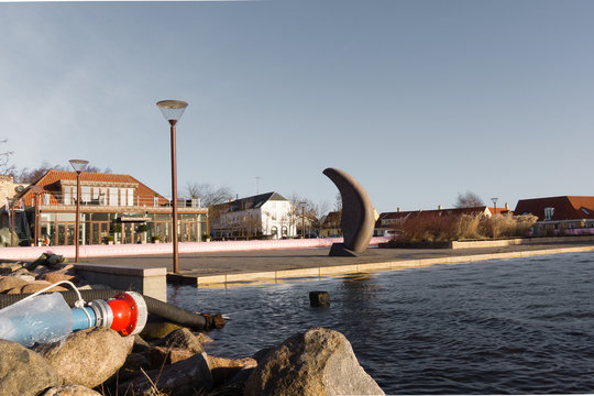 Pink water tube against the storm Urd in Frederikssund harbor, D