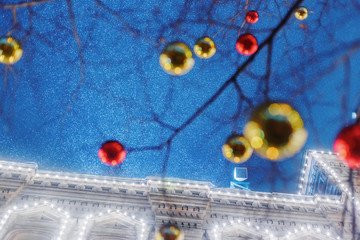 New year red and yellow balls ornamentation at elegant lighting building and blue sky background. Night scene.