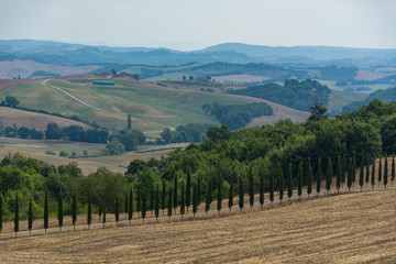 Fototapeta na wymiar Typical landscape in Tuscany, farmhouse on the hills of Val d'Orcia