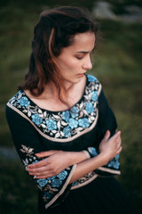 Young woman in long dress enjoying nature on the mountains