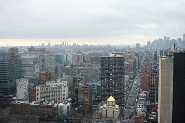 Midtown Manhattan cityscape from high floor on cloudy hazy day