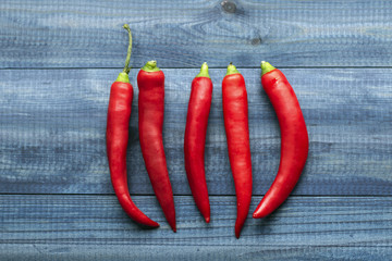 cayenne chilli peppers on blue wooden table