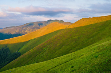 Mountains lit by the sun at dawn. Summer mountain landscape. Eur