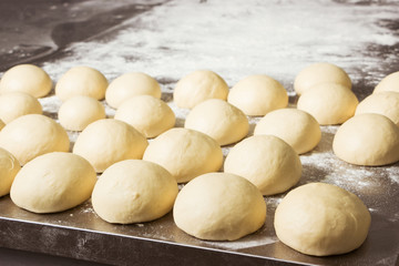 Finished dough in the bakery, in the steel table. Working process.