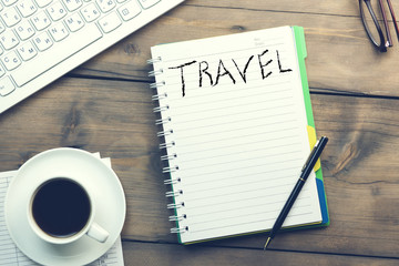 Word travel on notepad and keboard with coffee