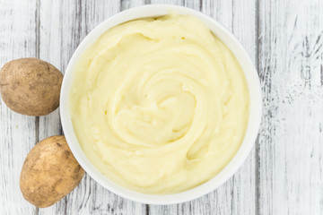 Wooden table with Mashed Potatoes (selective focus)