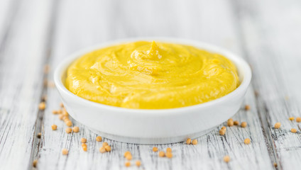 Fresh made Mustard on a rustic background