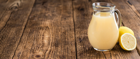 Wooden table with Lemon Juice (selective focus)