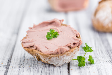 Wooden table with Liverwurst Sandwich (selective focus)