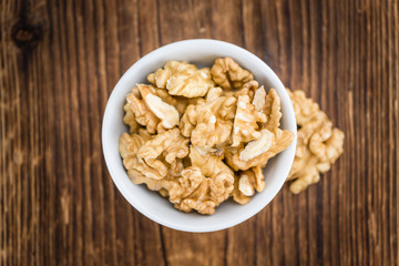 Cracked Walnuts on wooden background (selective focus)