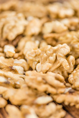 Portion of Cracked Walnuts on wooden background (selective focus
