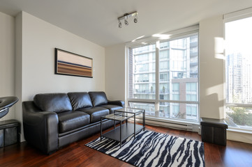 Modern apartment living room with a view of downtown. Interior design.