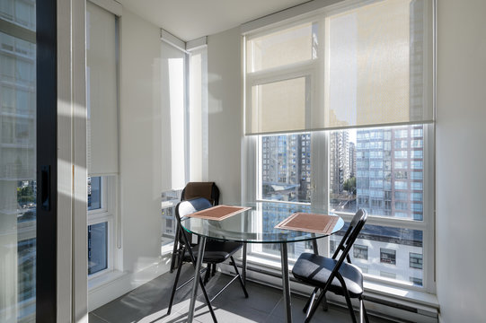 Bright apartment solarium dining room with a view of downtown. Interior design.