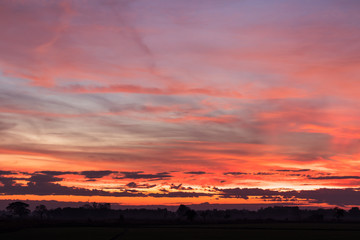 Sky orange and yellow countryside.