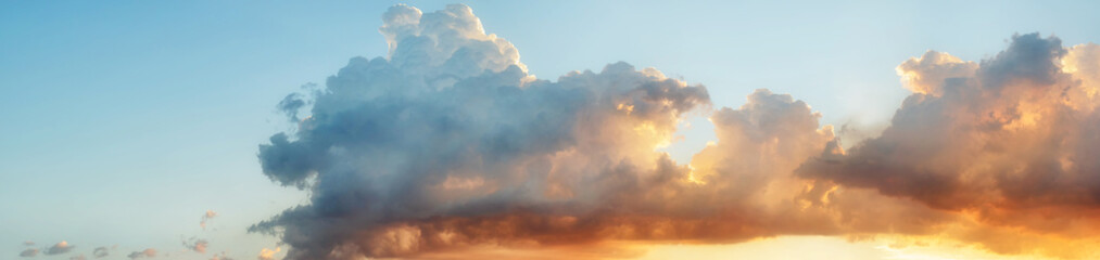 Pastel color heavenly cloud panorama at sunset against light blue gradient