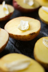 Potato with butter on a baking plate