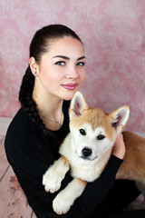 Young Lady With Her Cute Akita Puppy