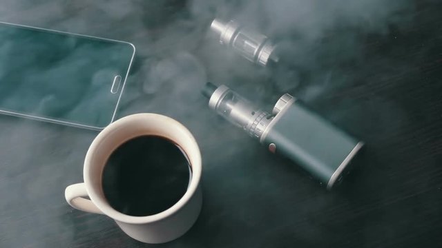 businessman with an e-cigarette on the stylish table
