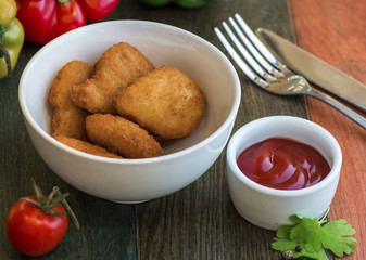 Very tasty nuggets with sauce and greens