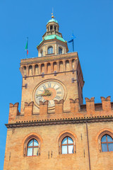 clock tower of Palazzo d'Accursio or Comunale overlooking Piazza Maggiore, today the seat of the municipality of Bologna in Italy.