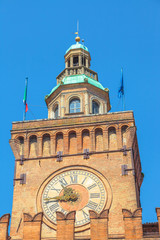 Close up of Accursi tower is also known as the Clock Tower of Palazzo d'Accursio or Comunale, Piazza Maggiore, Bologne in Italy in the blue sky.