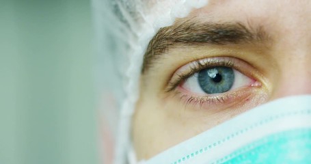 close up portrait of a surgeon or doctor with mask and headset ready for operation in hospital or clinic. The surgeon smiles safe and proud of himself. Concept of medicine, hospitals and doctors, care - Powered by Adobe