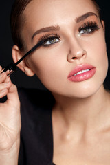 Beauty. Beautiful Woman Applying Black Mascara On Eyelashes