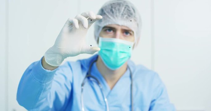 A physician, surgeon, examines a technological digital holographic plate represented the patient's body, the heart lungs, muscles, bones. Concept: Futuristic medicine, world assistance, and the future