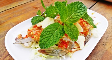 Spicy salad shrimp in fish sauce on wooden background ,  Thai Seafood.