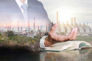 Double exposure of businessman hand hold,cityscape, urban, oil refinery industry plant and sunset in the evening as Energy and Technology concept.
