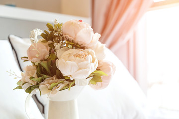Pink roses on white bed background