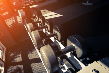 Rows of dumbbells in the gym with hign contrast and monochrome c