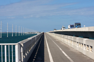 Florida Keys bridges. Old seven mile bridge, pedestrian area, new bridge with cars in traffic and...