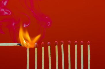 Burning matchsticks setting fire to its neighbors