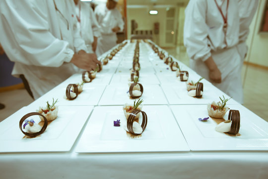 Chef  Decorating Dessert On The White Plate In Luxury Dinner Par