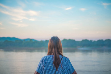 Fototapeta premium Woman looking away with River Background