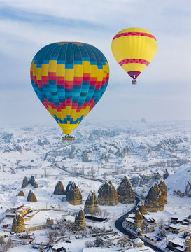 Hot air balloons and Cappadocia aerial view during winter