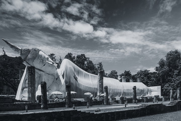 Obraz premium Buddha reclining or lie down to rest outdoor park at the temple in Thailand Black and white photography