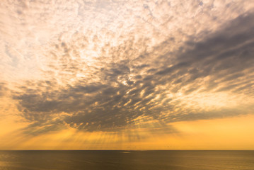 Rays of light shining down from the sky cloud with sea