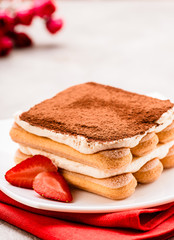 Tiramisu with strawberry on the table. Valentines concept.