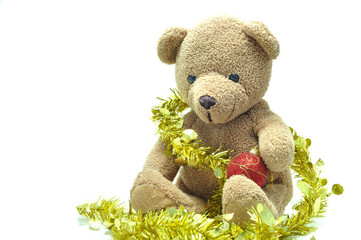 Cute teddy bear sitting and tied with gold ribbon X mas ball on