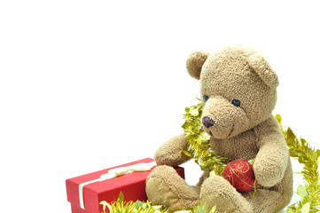 Cute teddy bear sitting and tied with gold ribbon X mas ball on