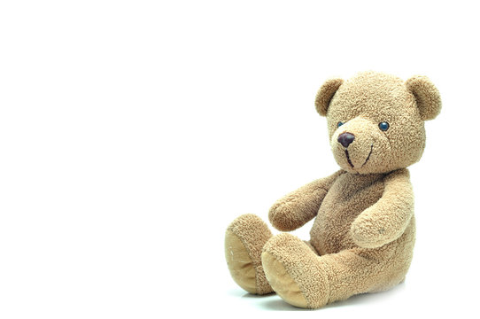 Brown teddy bear sitting on white background.