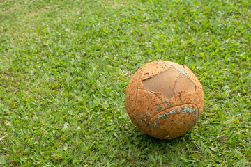 Plakat The old soccer ball on soccer field.