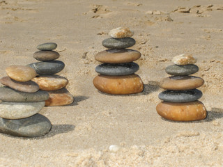 Fototapeta na wymiar Several piers of pebbles on the beach in pyramid