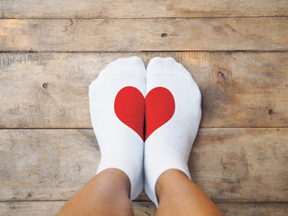  feet wearing white socks with red heart shape - 132291032